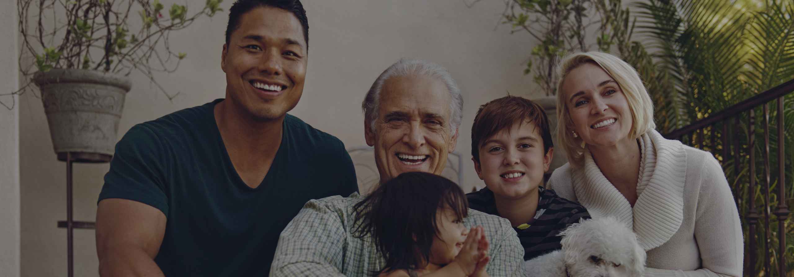 A multigenerational family sitting on the porch of their home in Scottsdale